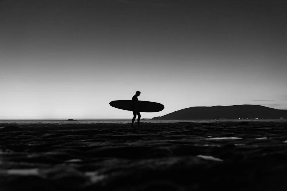 A surfer silhouetted against the ocean